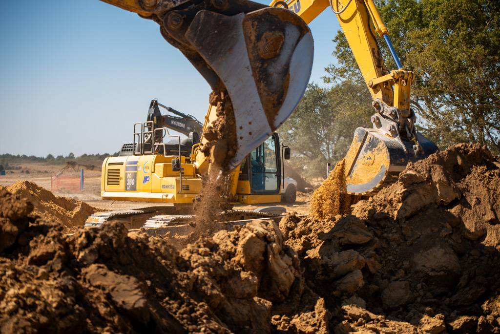 Heavy equipment performing infrastructure construction for a complex site development project in Texas