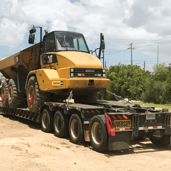 Construction equipment being transported to a Texas infrastructure project for coordinated logistics support