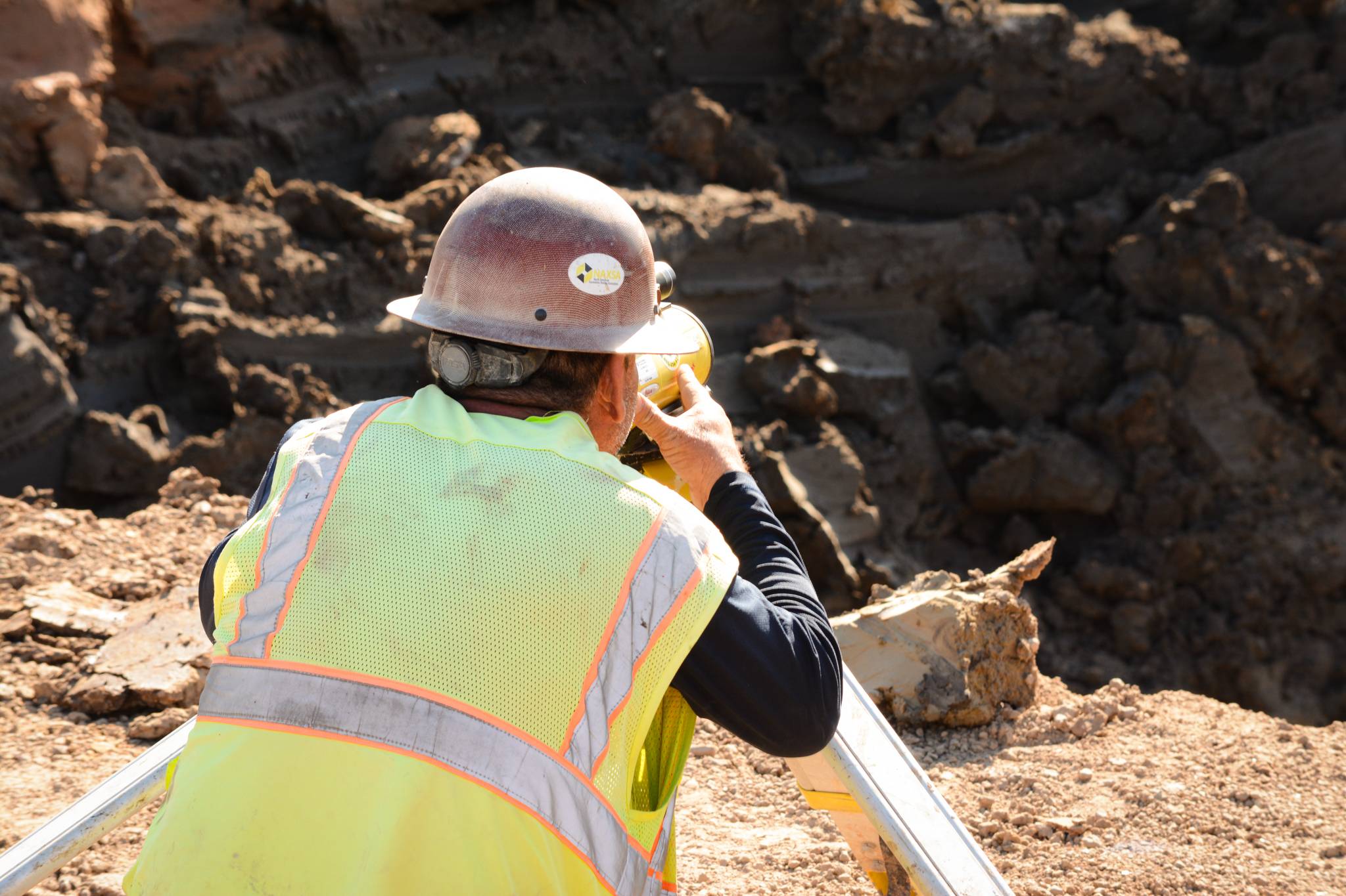 Survey crew laying out underground utility infrastructure for a Texas site development project