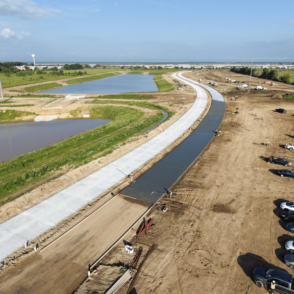 Aerial view of concrete roadway and drainage infrastructure construction in Texas