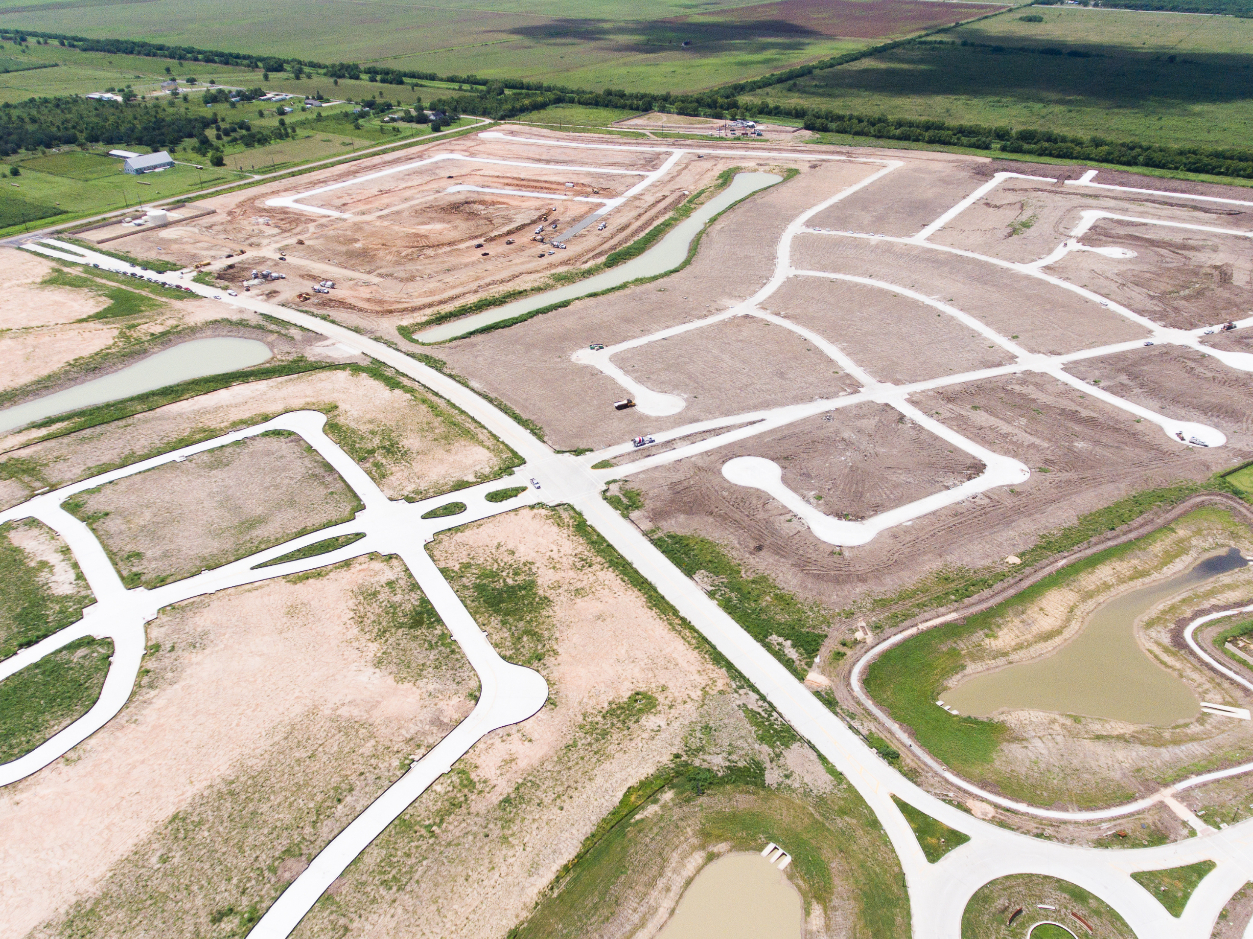 Aerial view of a coordinated site development project with roads, drainage and infrastructure under construction in Texas