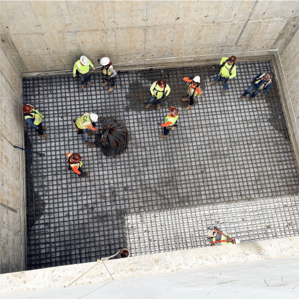 Construction crews coordinating storm drainage and underground utility infrastructure on a Texas project
